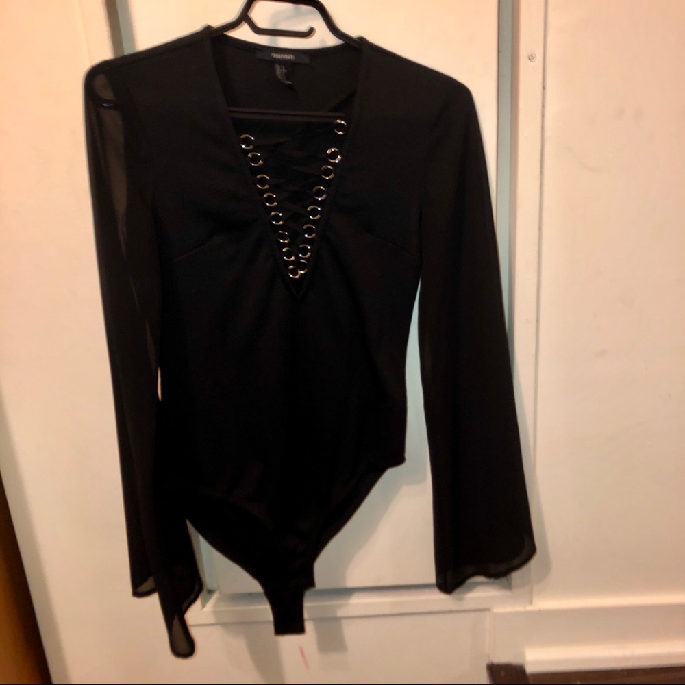 Long sleeve bodysuit with lace up low front.